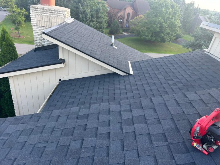 Certa Roofing finished shingle roof near stone fireplace chimney