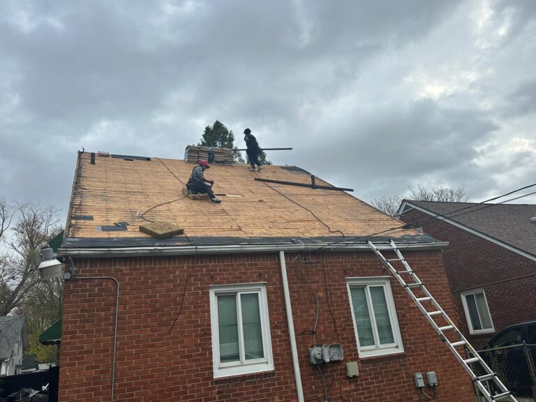 Certa Roofing crew replacing roof deck on brick house
