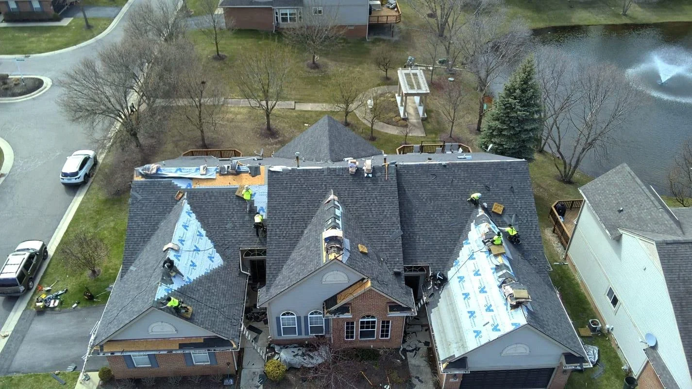 Certa Roofing crew installing a new shingle roof on a Michigan home